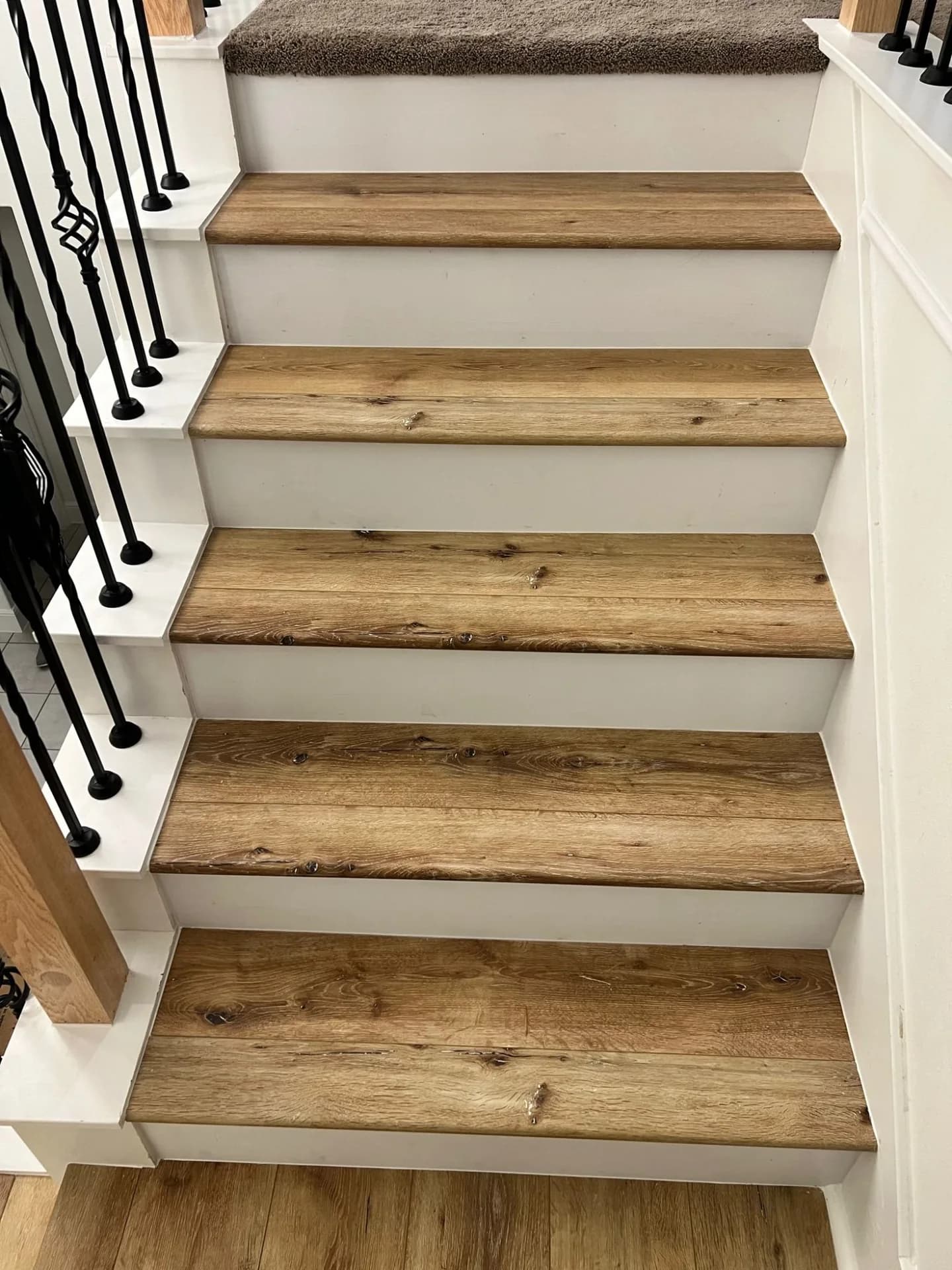 A staircase clad in rustic oak LVP